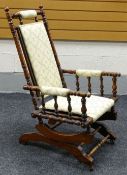 AN AMERICAN-STYLE SEMI-UPHOLSTERED ROCKING CHAIR of turned-wood form Provenance: Estate of Helen
