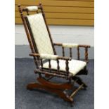 AN AMERICAN-STYLE SEMI-UPHOLSTERED ROCKING CHAIR of turned-wood form Provenance: Estate of Helen