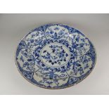 AN EIGHTEENTH CENTURY ENGLISH DELFT CHARGER the floral and insect decoration in underglaze blue,
