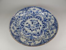 AN EIGHTEENTH CENTURY ENGLISH DELFT CHARGER the floral and insect decoration in underglaze blue,