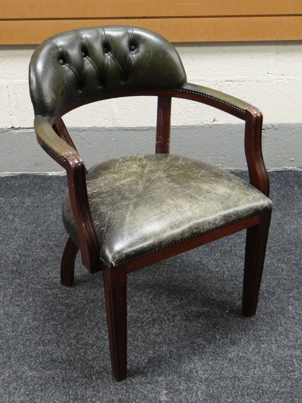 A BUTTONED GREEN LEATHER LIBRARY / DESK CHAIR