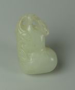 A CHINESE CARVED WHITE JADE TOGGLE of naturalistic form, 4cms long