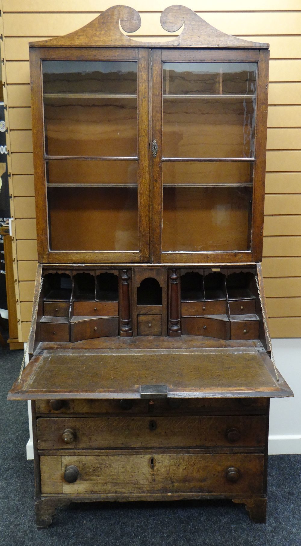 AN EARLY NINETEENTH CENTURY OAK BUREAU BOOKCASE having a two door glazed top with sloped front - Image 2 of 3