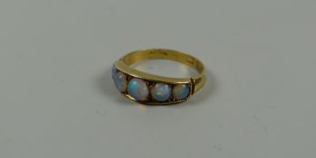 AN ANTIQUE GOLD RING set with five graduated opals, 2.6gms