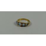 AN ANTIQUE GOLD RING set with five graduated opals, 2.6gms