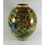A QAJAR-STYLE PAINTED POTTERY VASE of bulbous form & decorated with a floral garden design with
