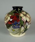 A 2009 MOORCROFT SQUAT NARROW NECK VASE in a trial for Ophelias Flowers pattern by V Lovatt, 12cms