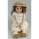 A MAX HANDWERCK BEBE ELITE BISQUE HEAD DOLL having weighted brown glass eyes, open mouth with