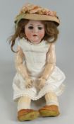 A MAX HANDWERCK BEBE ELITE BISQUE HEAD DOLL having weighted brown glass eyes, open mouth with