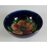 A MOORCROFT DEEP BLUE GROUND FLORAL FOOTED BOWL, 13cms diam