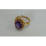 A 9CT YELLOW GOLD & AMETHYST OVAL RING