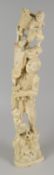 A MEIJI PERIOD IVORY OKIMONO featuring balancing figures with bird, vine & basket on a