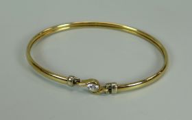 A 9K YELLOW GOLD BANGLE WITH SOLITAIRE CZ