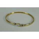 A 9K YELLOW GOLD BANGLE WITH SOLITAIRE CZ