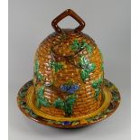 A MINTON MAJOLICA CHEESE DOME & STAND in the form of a beehive, with grapevines & having a loop