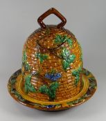 A MINTON MAJOLICA CHEESE DOME & STAND in the form of a beehive, with grapevines & having a loop