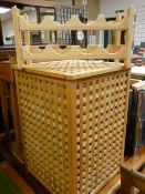 Modern light wood linen basket and a small wine rack