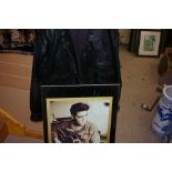 Framed poster of Elvis Presley in uniform with guitar and a leather jacket