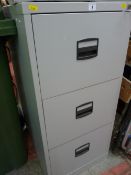 Three drawer grey metal filing cabinet with key
