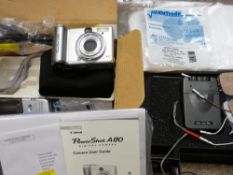 Canon Supershot digital camera and a cased portable dual channel tens machine