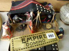 Box of dominoes in a British Empire domino tin and a model depicting a desert camp scene