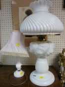 Oil lamp with milk glass shade and reservoir and a table lamp