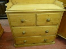 A VICTORIAN STRIPPED PINE CHEST of two short over two long drawers with upper splashback, 103 cms