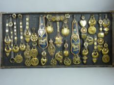 SHIRE/HEAVY HORSE BRASSWARE - a 4ft 1ins display board containing Victorian and later martingales