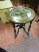 A MAHOGANY CIRCULAR SIDE TABLE with mirrored inset top, the 57 cms diameter top with carved edge