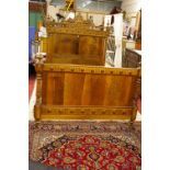 A PAIR OF VINTAGE EUROPEAN WALNUT 4ft 6ins BED ENDS with connecting irons, the headboard with carved
