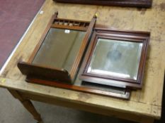AN EDWARDIAN GALLERY TOP DRESSING MIRROR with shelf, with two other mahogany framed wall mirrors
