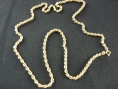 A NINE CARAT GOLD MUFF CHAIN, 60 cms long, 8.7 grms