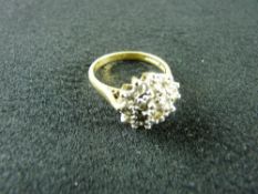 AN EIGHTEEN CARAT GOLD DIAMOND CLUSTER RING having a centre diamond of visual estimate 0.5 carat and