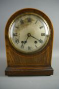AN EDWARDIAN MAHOGANY DOME TOPPED MANTEL CLOCK, the front with boxwood stringing surrounding a