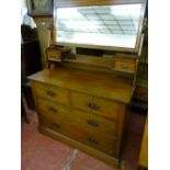 AN EDWARDIAN MAHOGANY DRESSING CHEST with two long and two short drawers having a tilting mirror