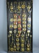 SHIRE/HEAVY HORSE BRASSWARE - a 4ft 1ins display board containing Victorian and later martingales
