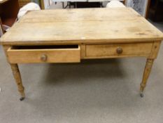 AN ANTIQUE STRIPPED PINE FARMHOUSE KITCHEN TABLE with large frieze drawers having turned wooden