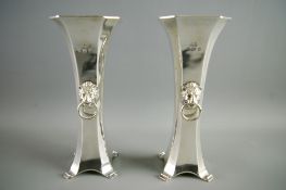 A PAIR OF ATTRACTIVELY SHAPED SILVER ROSE VASES, the columns of swept form with square tops, four-
