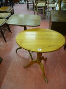 A STRIPPED PINE TILT TOP TRIPOD TABLE, 66.5 cms high and a mahogany tripod table, 71.5 cms high