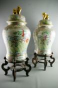 A LARGE PAIR OF CHINESE EXPORT CANTON VASES with covers and wooden stands, typical Famille Rose