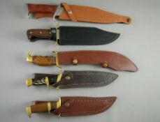 FIVE REPLICA DISPLAY KNIVES all in leather sheaths, various wood and horn grips with metal mounts,