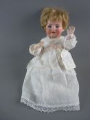 A BAHR & PROSCHILD CERAMIC HEADED DOLL having opening eyes, closed mouth and original lace edged