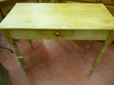 A VINTAGE STRIPPED PINE SINGLE DRAWER SIDE TABLE on turned tapering supports, 73.5 cms high, 90.5