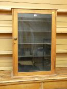A SINGLE GLAZED DOOR STRIPPED PINE CUPBOARD with interior adjustable shelves, 89 cms high, 62 cms