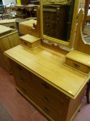 A STRIPPED SATINWOOD MIRRORED DRESSING CHEST having a shaped top central mirror and shaped
