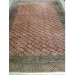 A GOOD LARGE EASTERN WOOLLEN WOVEN CARPET, red ground multi-bordered with a repeating segmented