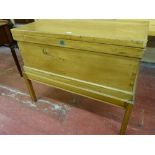 A VINTAGE PINE LIDDED BLANKET CHEST with brass carry handles on an associated stand, 81 cms high