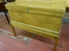 A VINTAGE PINE LIDDED BLANKET CHEST with brass carry handles on an associated stand, 81 cms high