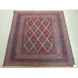 A TRIBAL CAZAK RUG, blue and red ground with central repeating diamond pattern and multiple