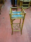 A VICTORIAN BAMBOO PLANTER STAND with Majolica tile insert and embossed brass caps, 81.5 cms high
